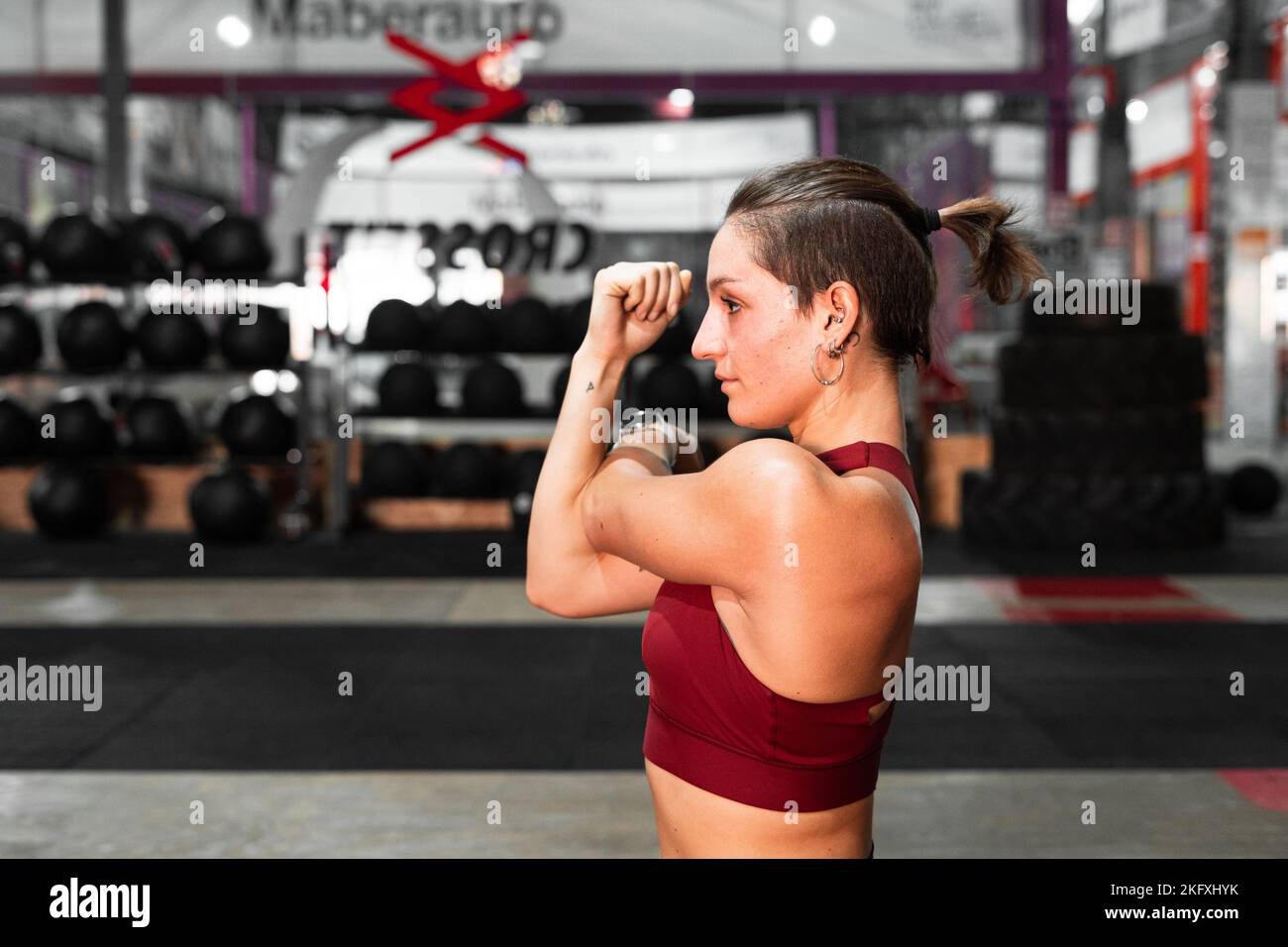 closeup profile bust of young caucasian woman doing sports with arms