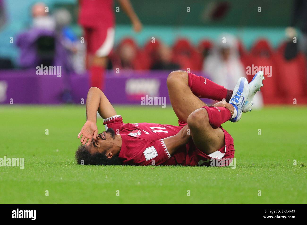 Al Khor, Qatar. 20th Nov, 2022. Karim Boudiaf of Qatar injured during the FIFA World Cup Qatar 2022 Group A match between Qatar and Ecuador at Al Bayt Stadium, Al Khor, Qatar on 20 November 2022. Photo by Peter Dovgan. Editorial use only, license required for commercial use. No use in betting, games or a single club/league/player publications. Credit: UK Sports Pics Ltd/Alamy Live News Stock Photo