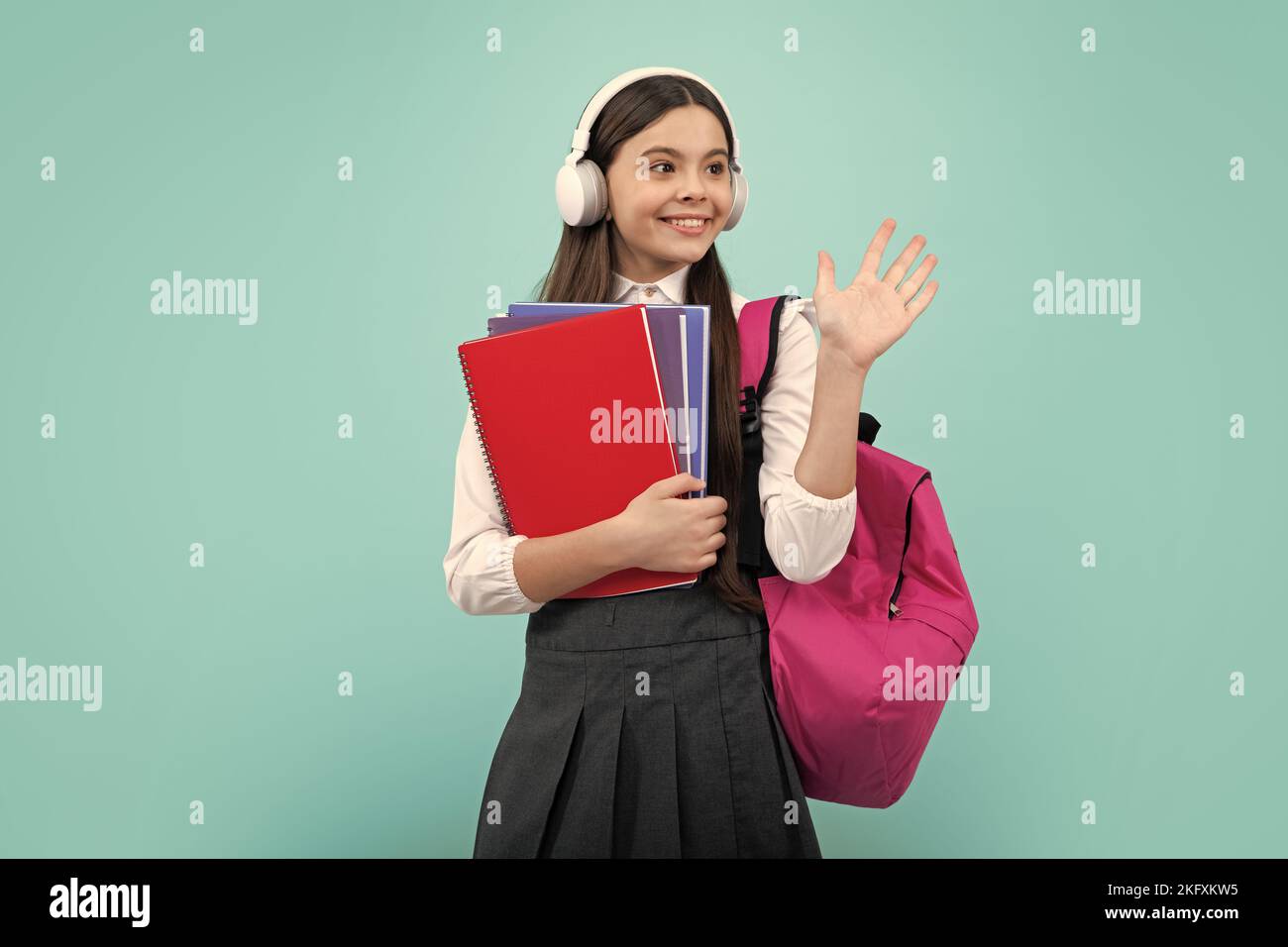 Schoolchild, teenage student girl with headphones and school bag ...