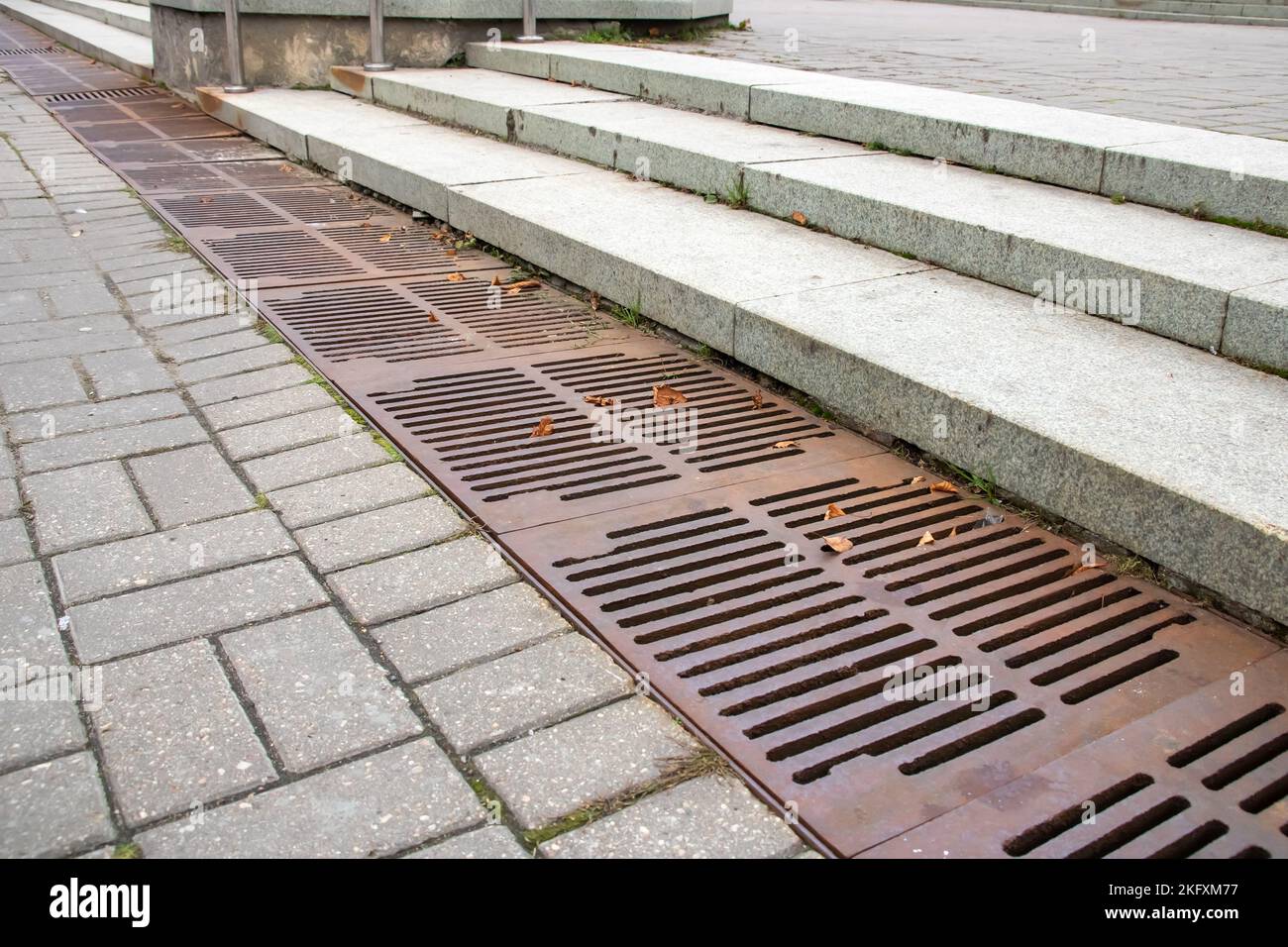 The sewer grate on the sidewalk is rusty close up Stock Photo Alamy