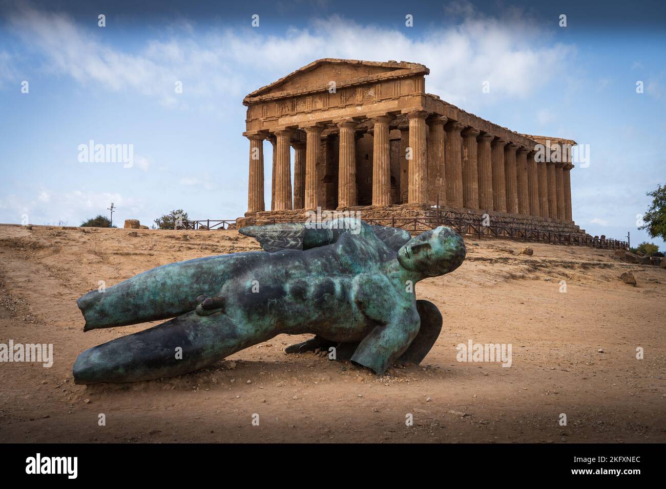 Bronze statue lying at the front of the ancient Greek Concordia temple in the Valley of the Temples. Agrigento. Sicily. Italy. Stock Photo