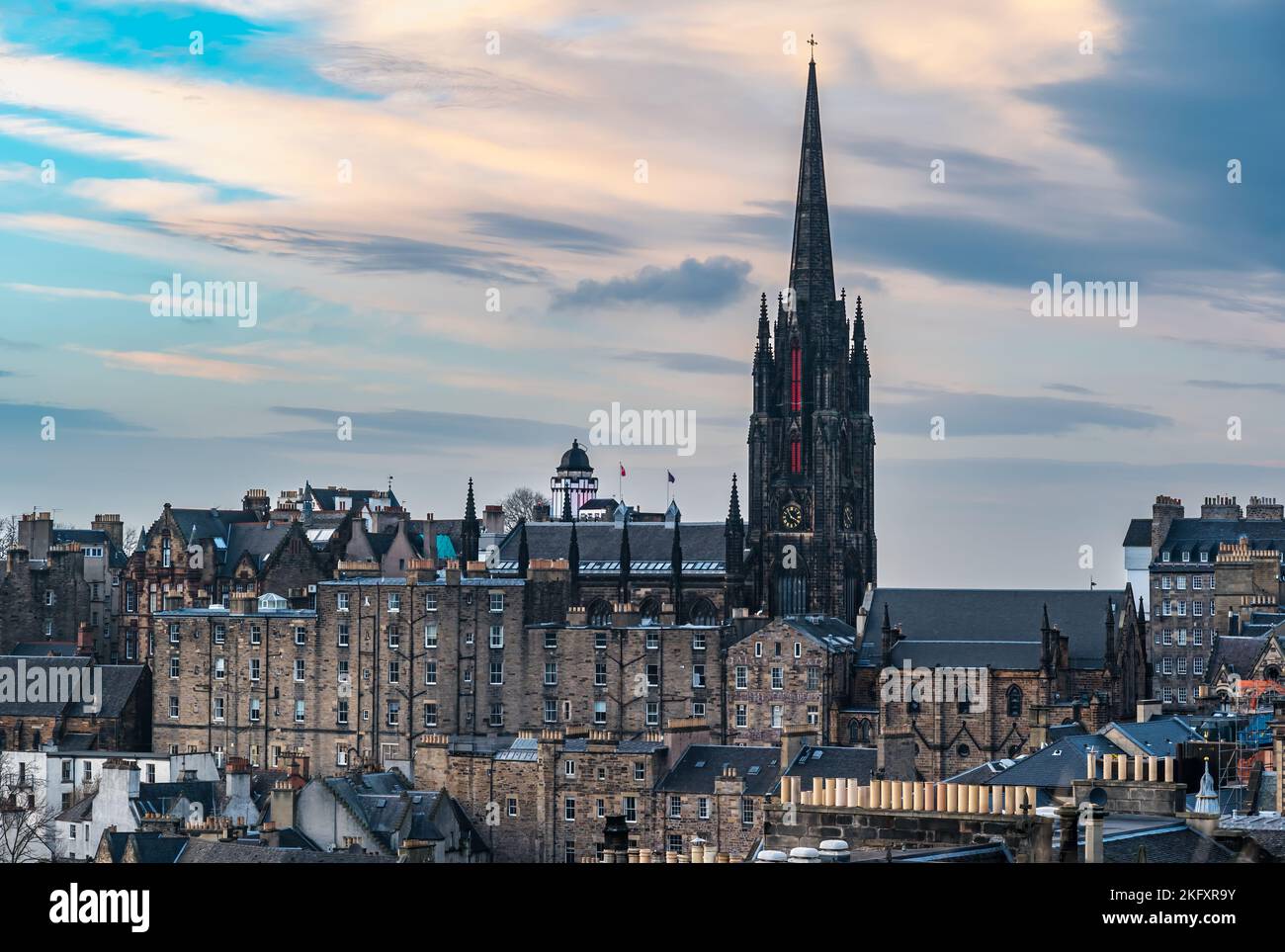 View over rooftops of Royal Mile historic buildings with The Hub spire at dusk, Edinburgh, Scotland, UK Stock Photo