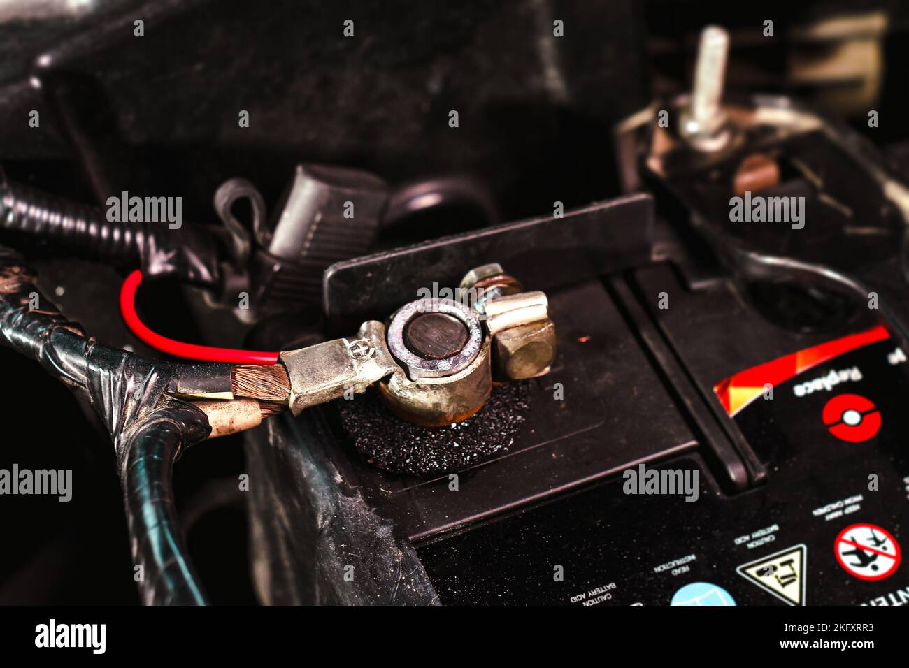 The positive terminal of the car battery with the connection wires of