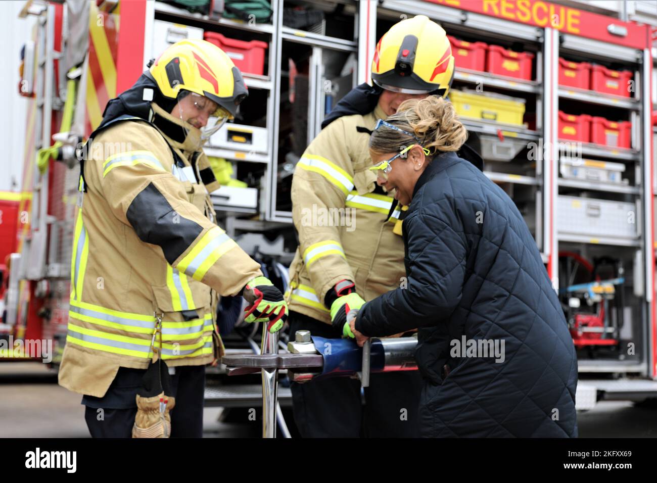 Members of the Sembach Fire Department show a civilian member of the