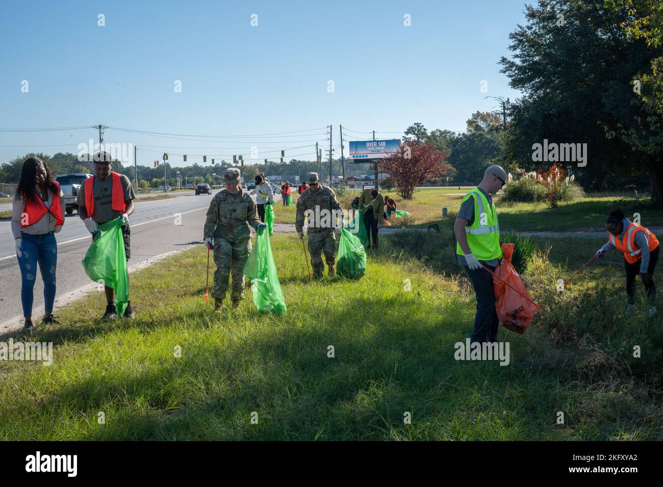 U s army central volunteers pick up trash during an organized cleanup