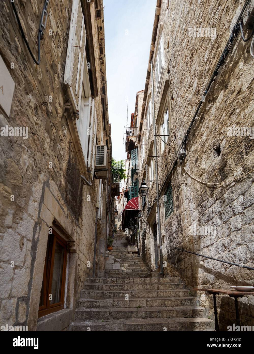 A vertical shot of a narrow street with stairs in an old town Stock ...