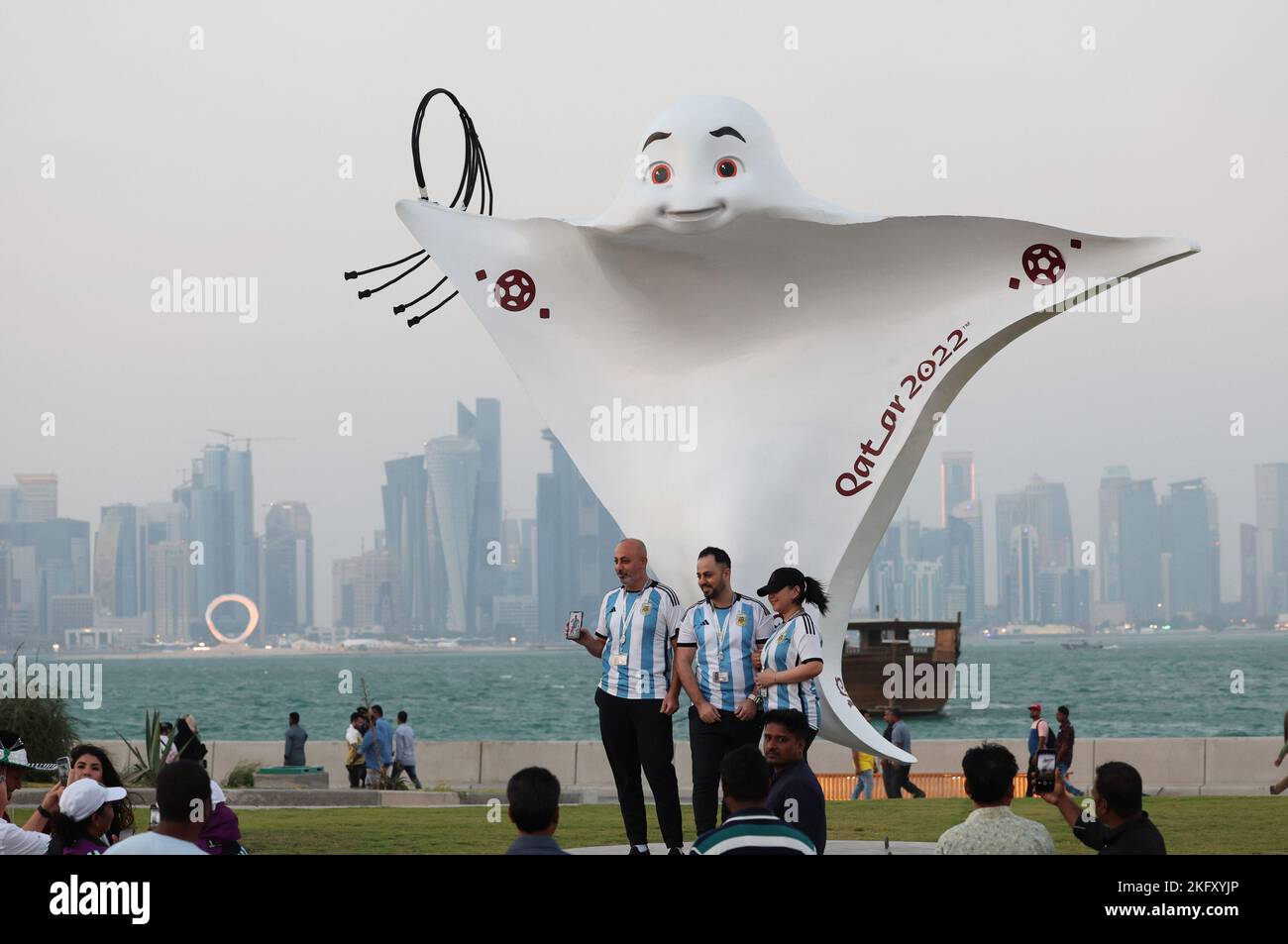 Doha, Qatar. 20th Nov, 2022. People pose with the 2022 Qatar FIFA World Cup official mascot La'eeb at Al Bidda park in Doha, Qatar, Nov. 20, 2022. Credit: Meng Yongmin/Xinhua/Alamy Live News Stock Photo