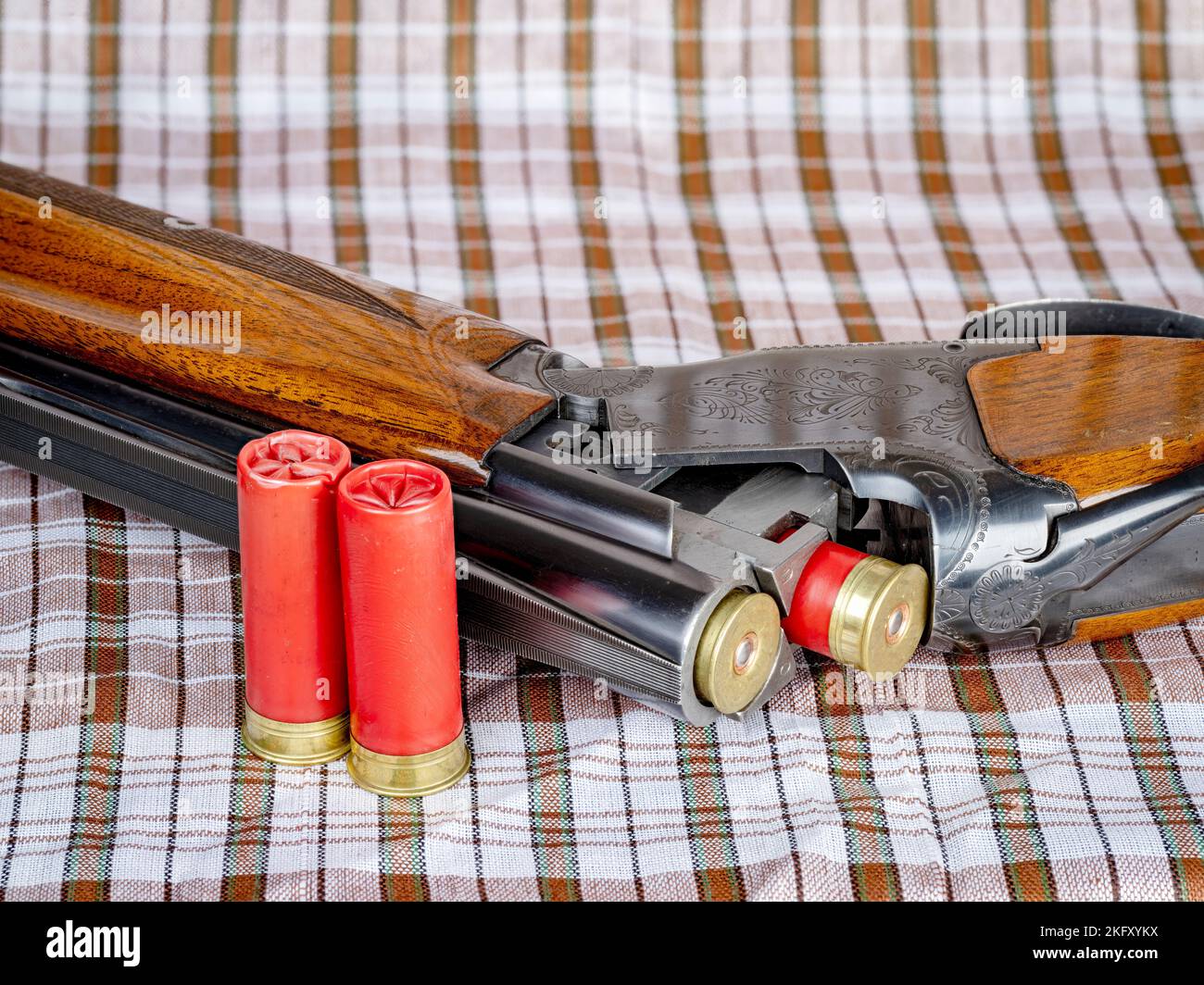 Over and under shotgun with red shotshells Stock Photo - Alamy