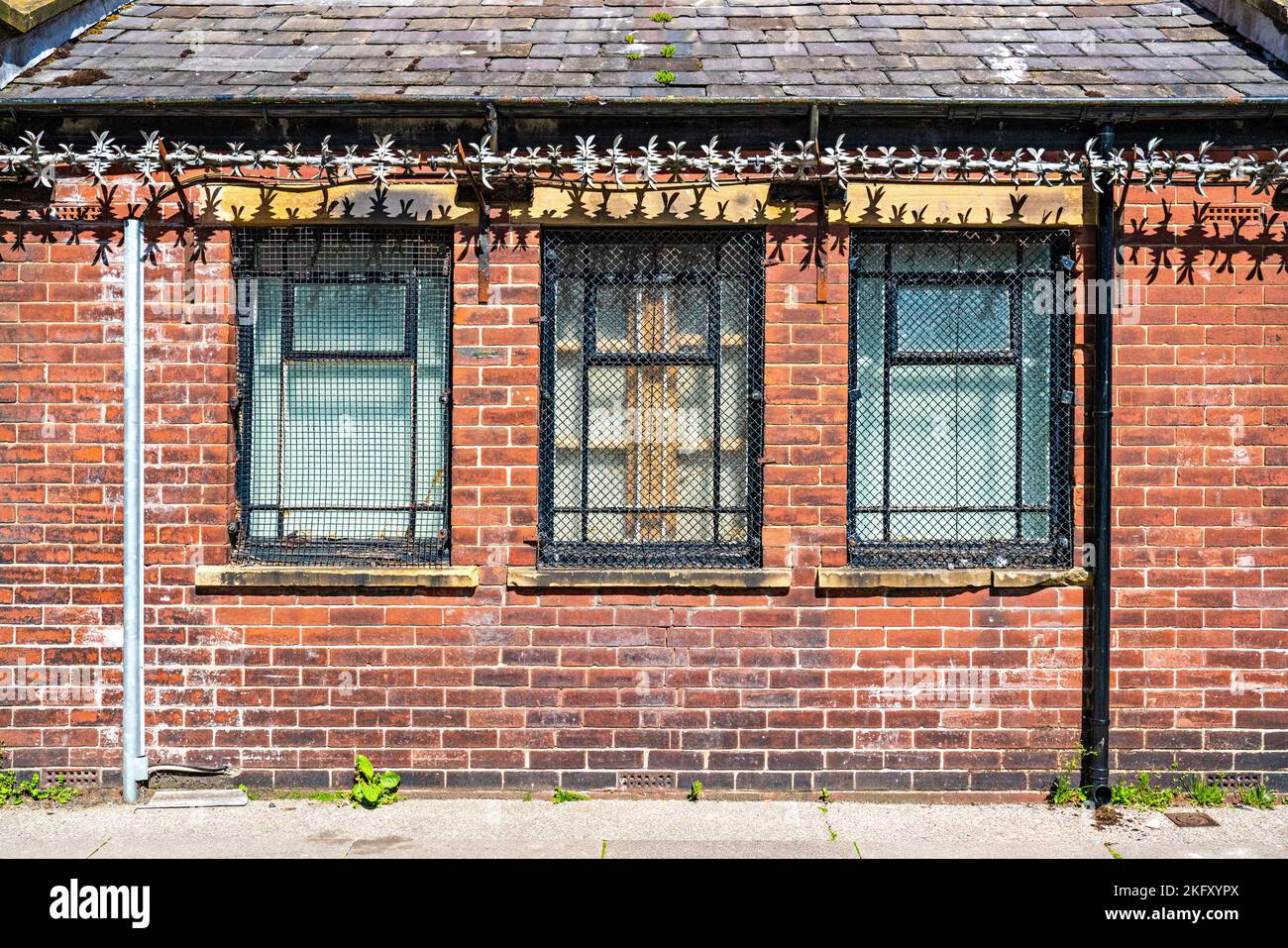 Three windows with security grills in town Stock Photo