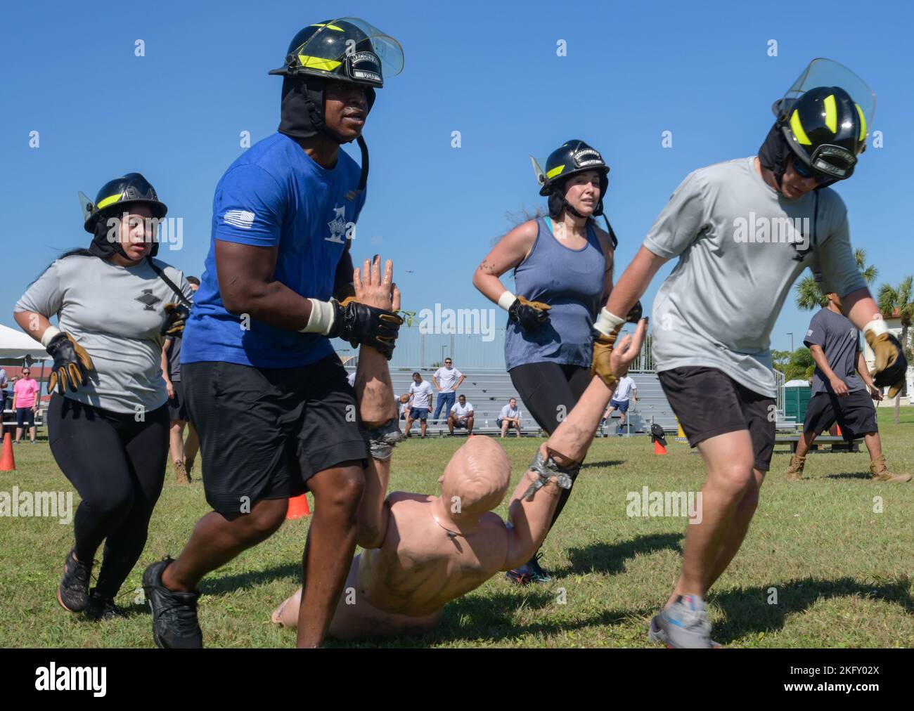 Members of “Team Diamond Sharp” carry a mannequin during the Fire Muster race at MacDill Air