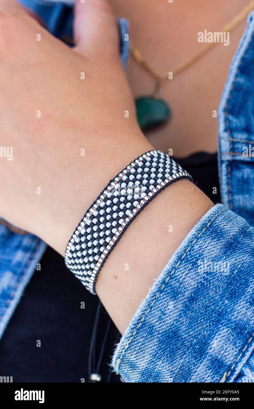 A vertical shot of a Friendship bracelet on a female wrist Stock Photo