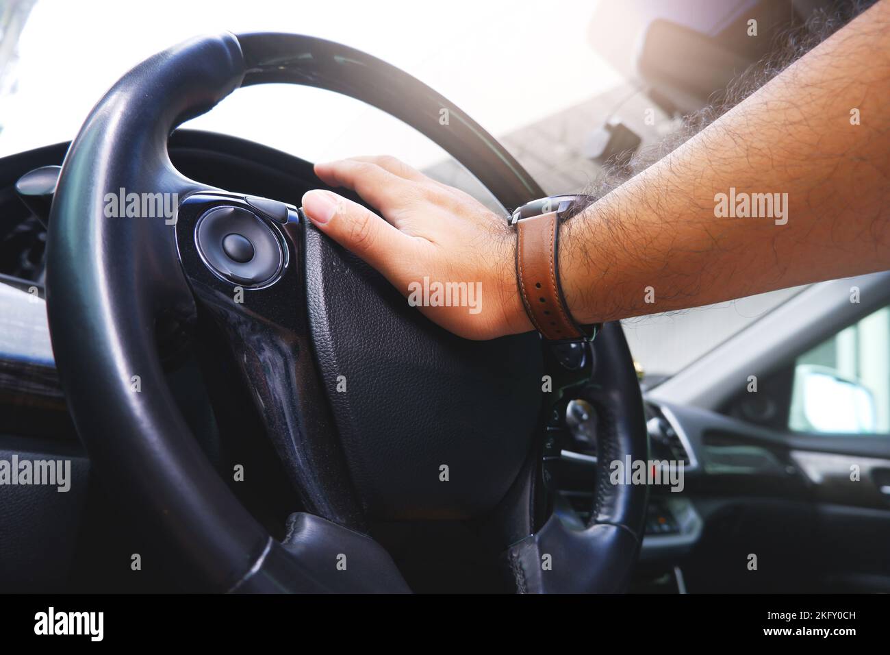 Driver hand pressing on steering wheel honking horn Stock Photo Alamy