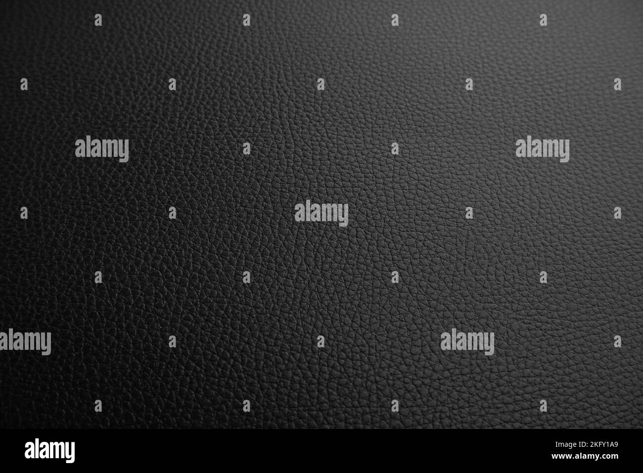 Black leather textured background with a lowlight Stock Photo