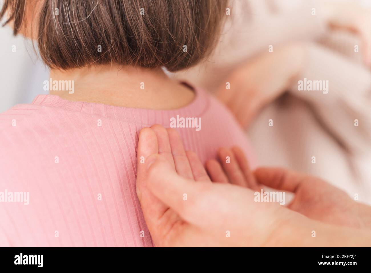 A close-up shot of female hands giving shoulder massage to a pregnant woman - Hypnobirthing concept Stock Photo