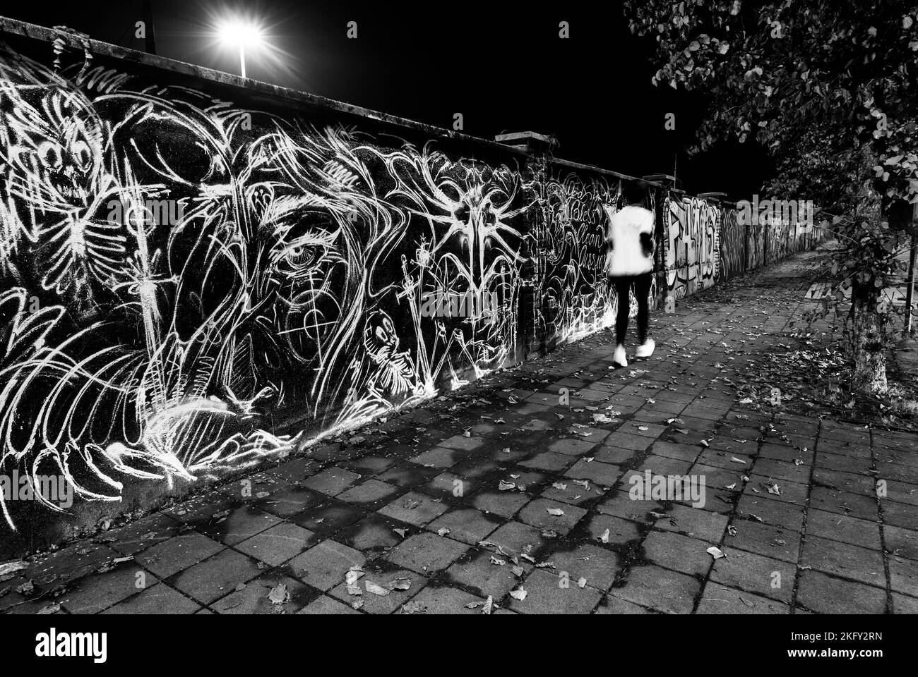 Runner runs at night in Milan Stock Photo