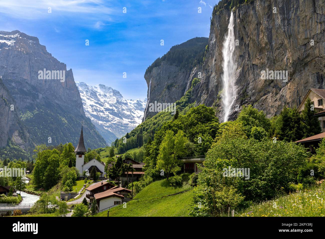 Landscape view of a part of Lauterbrunnen in Switzerland. Snow covered Alps  in the background and the Staubbach waterfall on the right Stock Photo -  Alamy