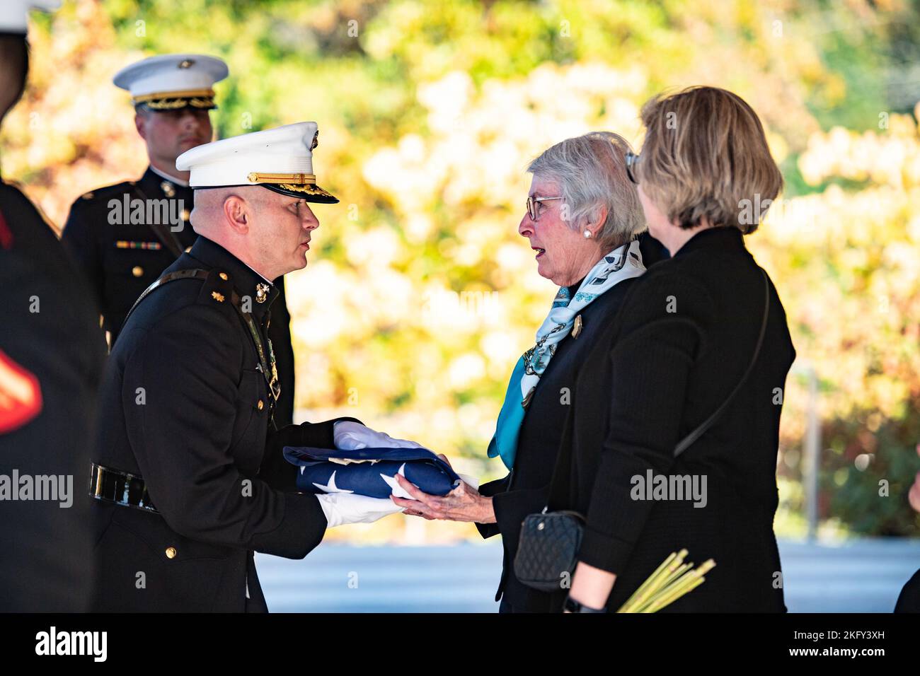 The U.S. flag is presented to Betty O'Donnell following military funeral honors with funeral escort for her husband, U.S. Marine Corps Maj. Brendan O’Donnell, in Section 83 of Arlington National Cemetery, Arlington, Va., Oct. 14, 2022.    Maj. O’Donnell entered the Marine Corps in October of 1950 and fought in the Korean War as a second lieutenant. By early April 1951, Maj. O’Donnell had become a platoon leader in Company D, 2nd Battalion of the 7th Marine Regiment, supporting the Army’s 1st Cavalry Division. His platoon was fighting to the Kansas Line, along the 38th parallel — the dividing l Stock Photo