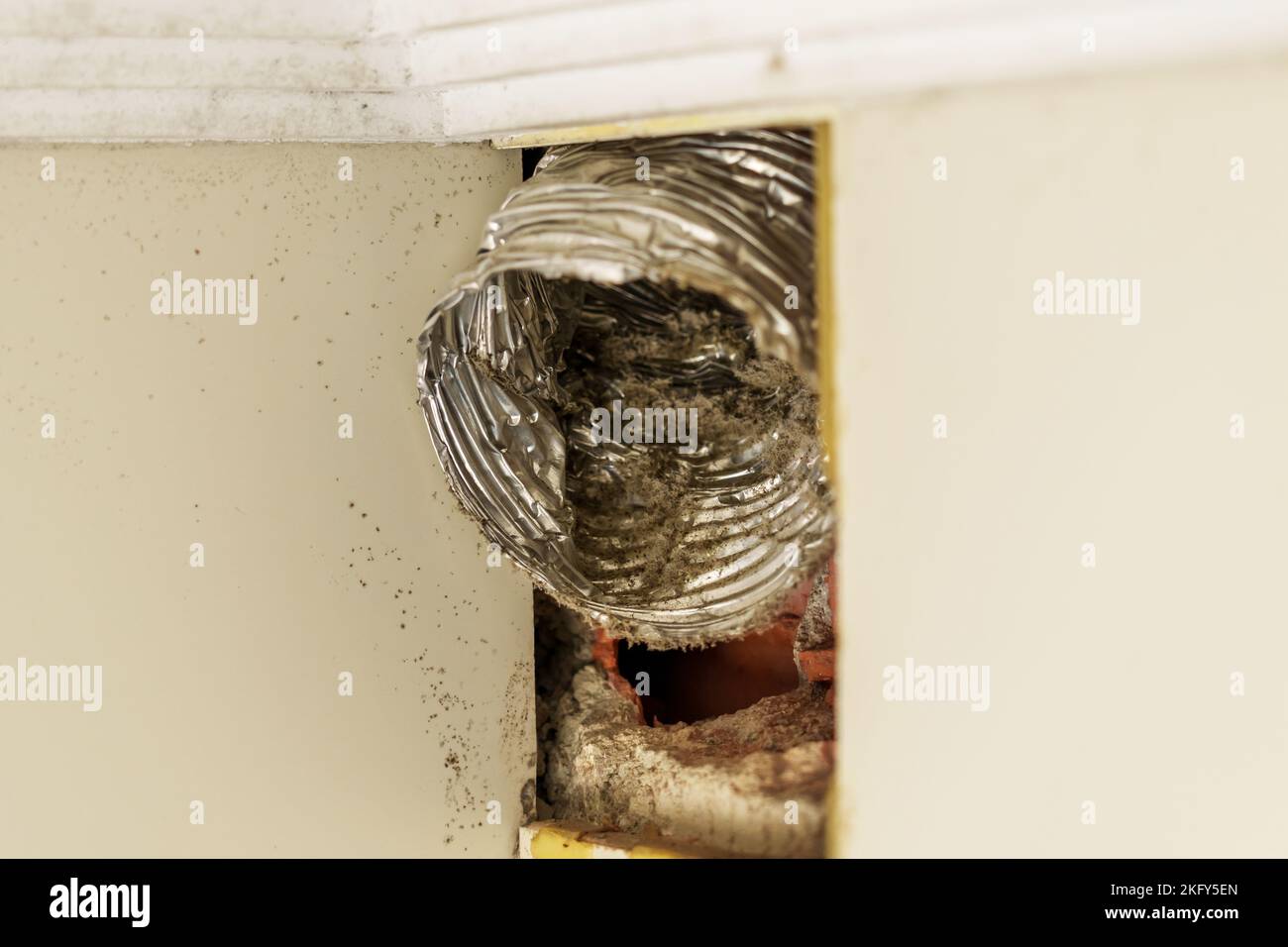 Damaged broken corrugated ventilation pipe with dust and dirt inside in
