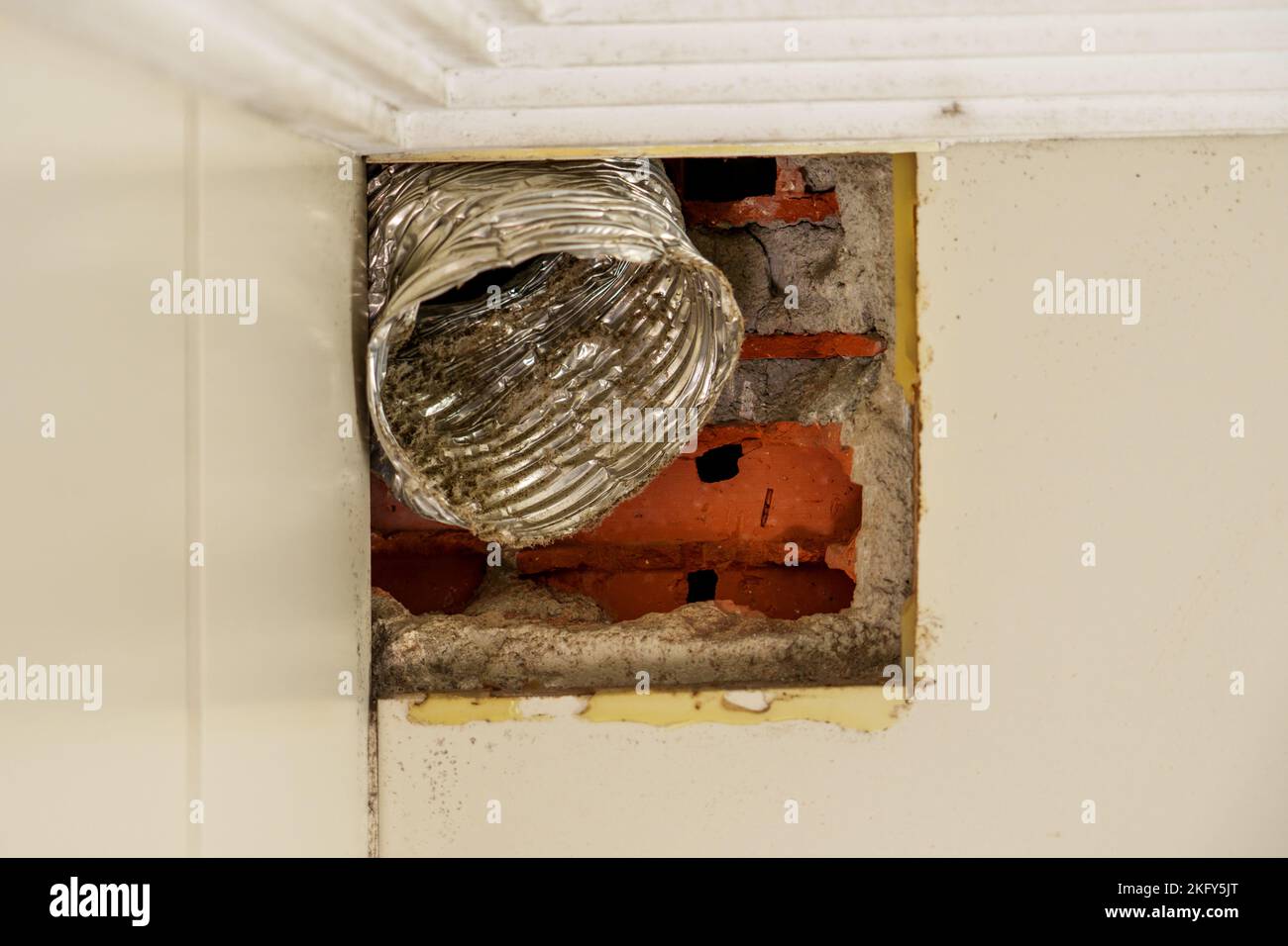 Damaged broken corrugated ventilation pipe with dust and dirt inside in