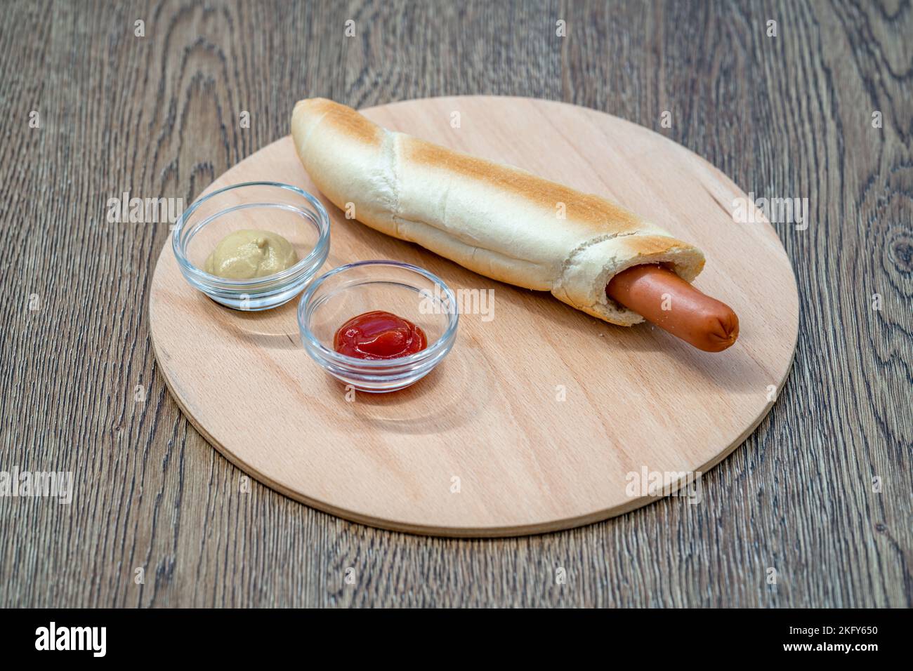 hot dog in a roll with mustard and ketchup Stock Photo