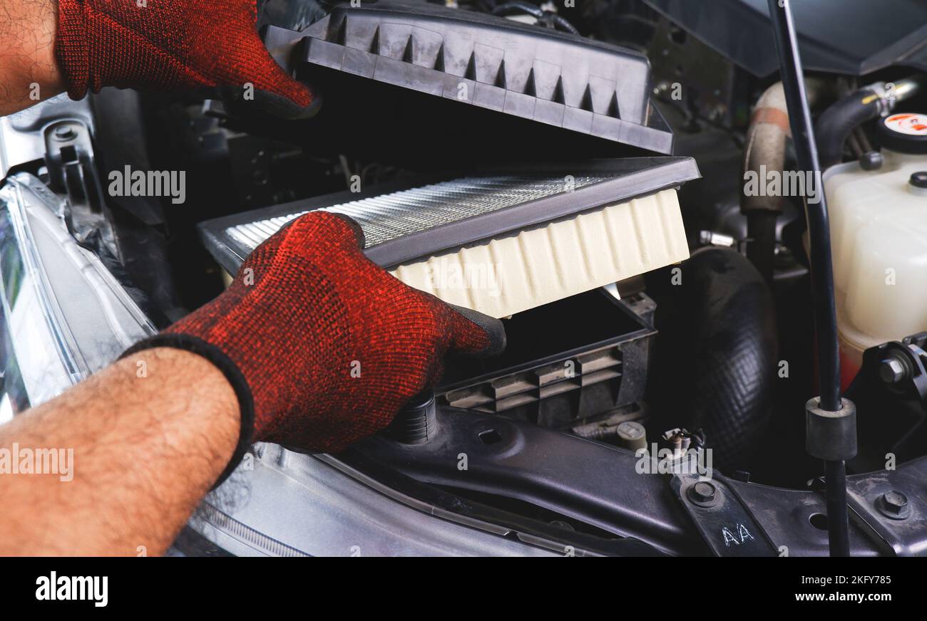 Car air filter being inserted into air filter box in the automobile