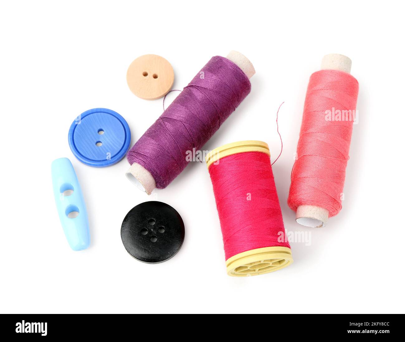 Colorful thread spools and buttons on white background Stock Photo - Alamy