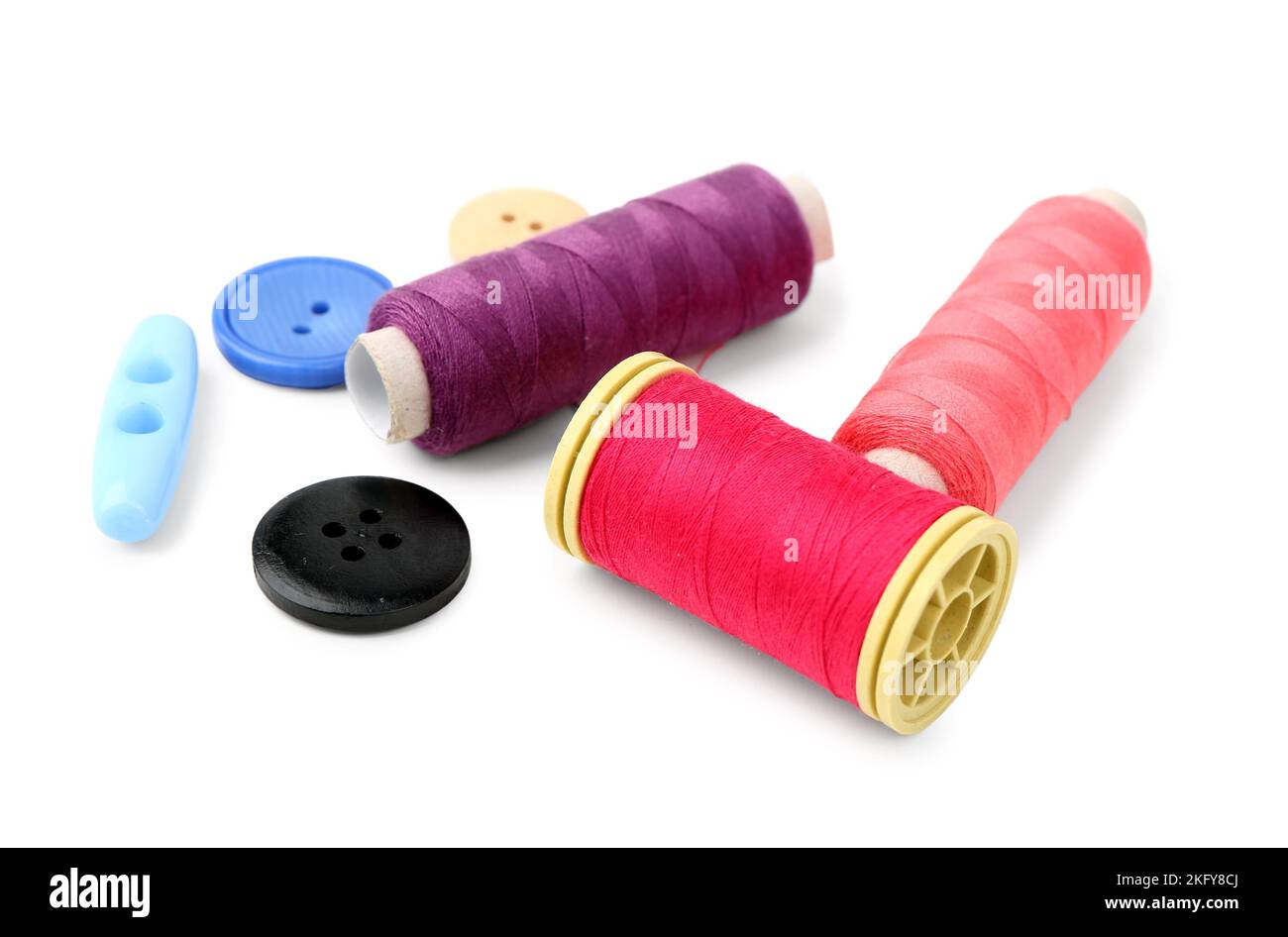 Colorful thread spools and buttons on white background Stock Photo - Alamy
