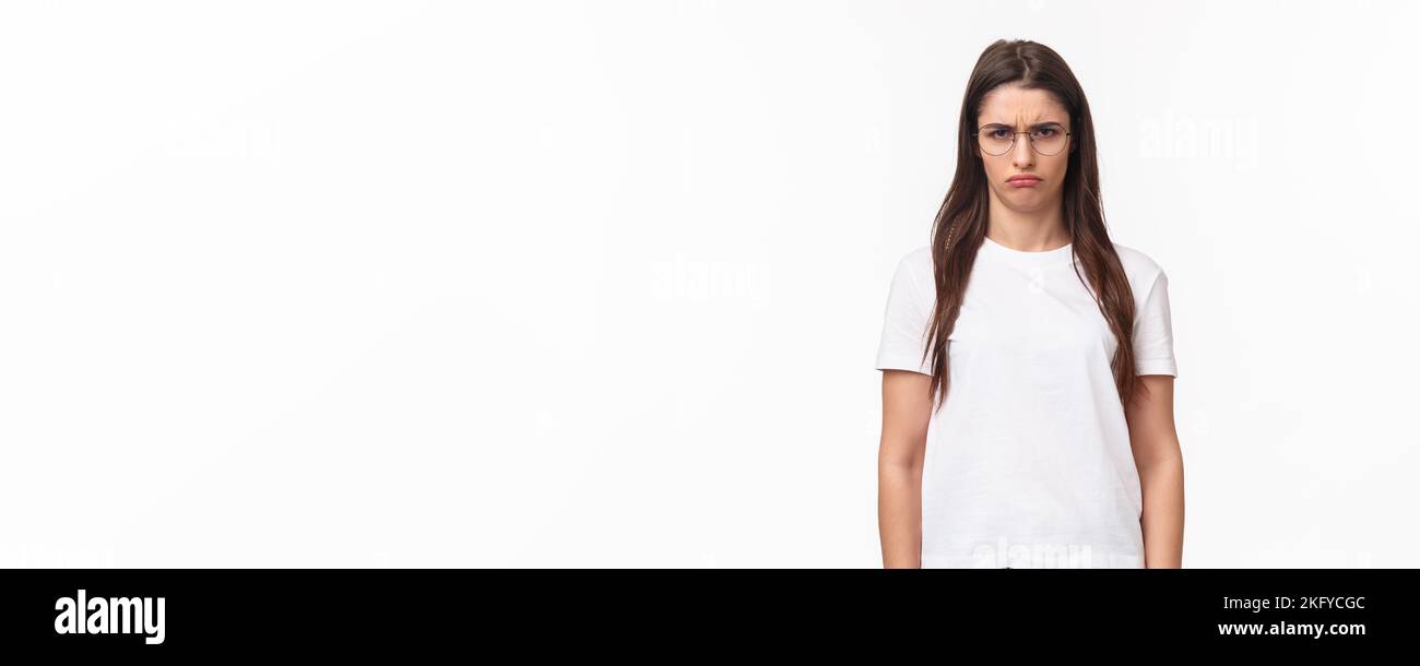 Waist-up portrait of sulking young offended gloomy girl, look with contempt camera, squinting blame person for spoiling her holiday, frowning grumpy Stock Photo