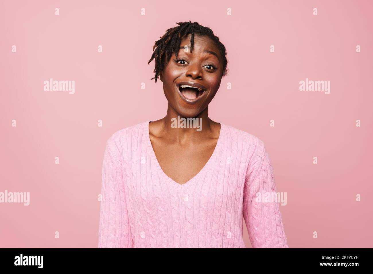 Black Excited Woman With Dreadlocks Expressing Surprise At Camera