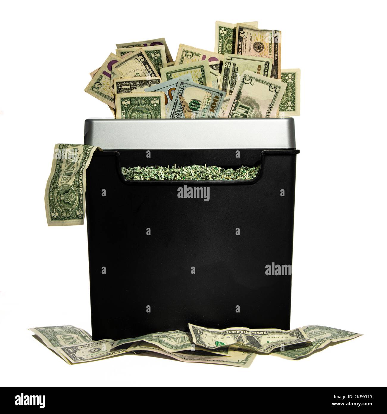 A pile of American dollars being shredded in a shredder Stock Photo