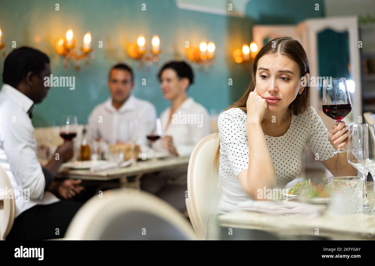 Lonely woman bored sitting table hi-res stock photography and images ...