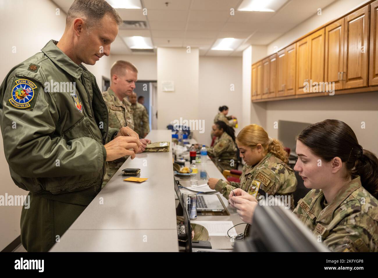 U.S. Air Force Airmen assigned to the 23rd Wing process through a personnel deployment function line at Moody Air Force Base, Georgia, Oct. 14, 2022. The PDF line ensures personnel are properly equipped with government travel cards, valid identification, and deployment documentation, as well as receiving any required vaccinations. The 23rd Wing deployed A-10C Thunderbolt II aircraft and support personnel to Andersen Air Force Base, Guam for a routine Dynamic Force Employment Operation. Stock Photo