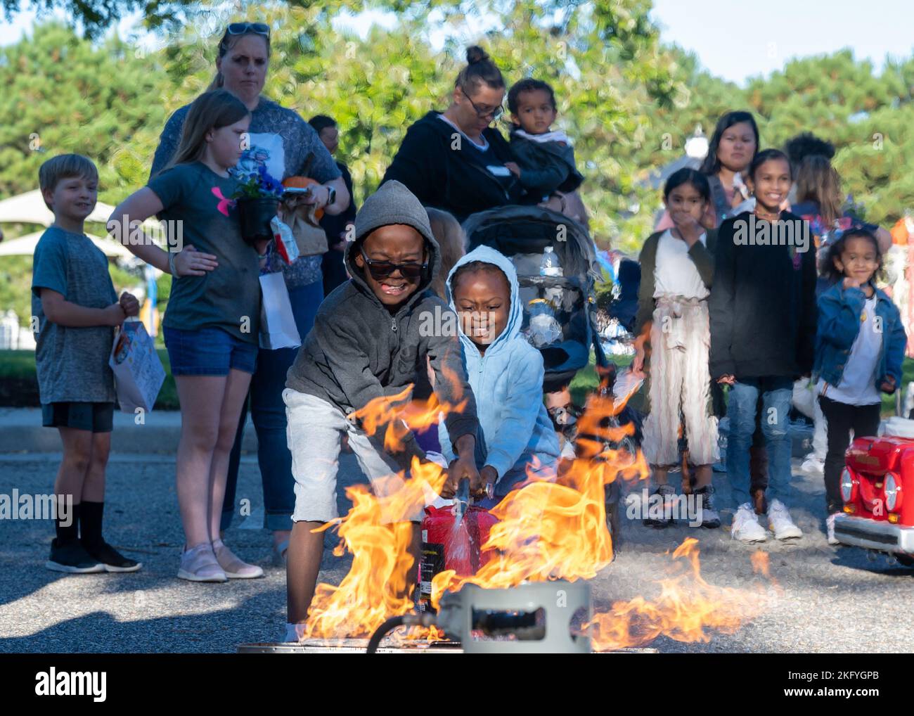 Children extinguish a propane fire during the Fire Safety Festival at