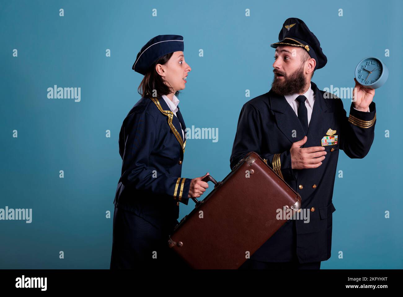 Flight attendant and pilot running late at airport, holding retro alarm