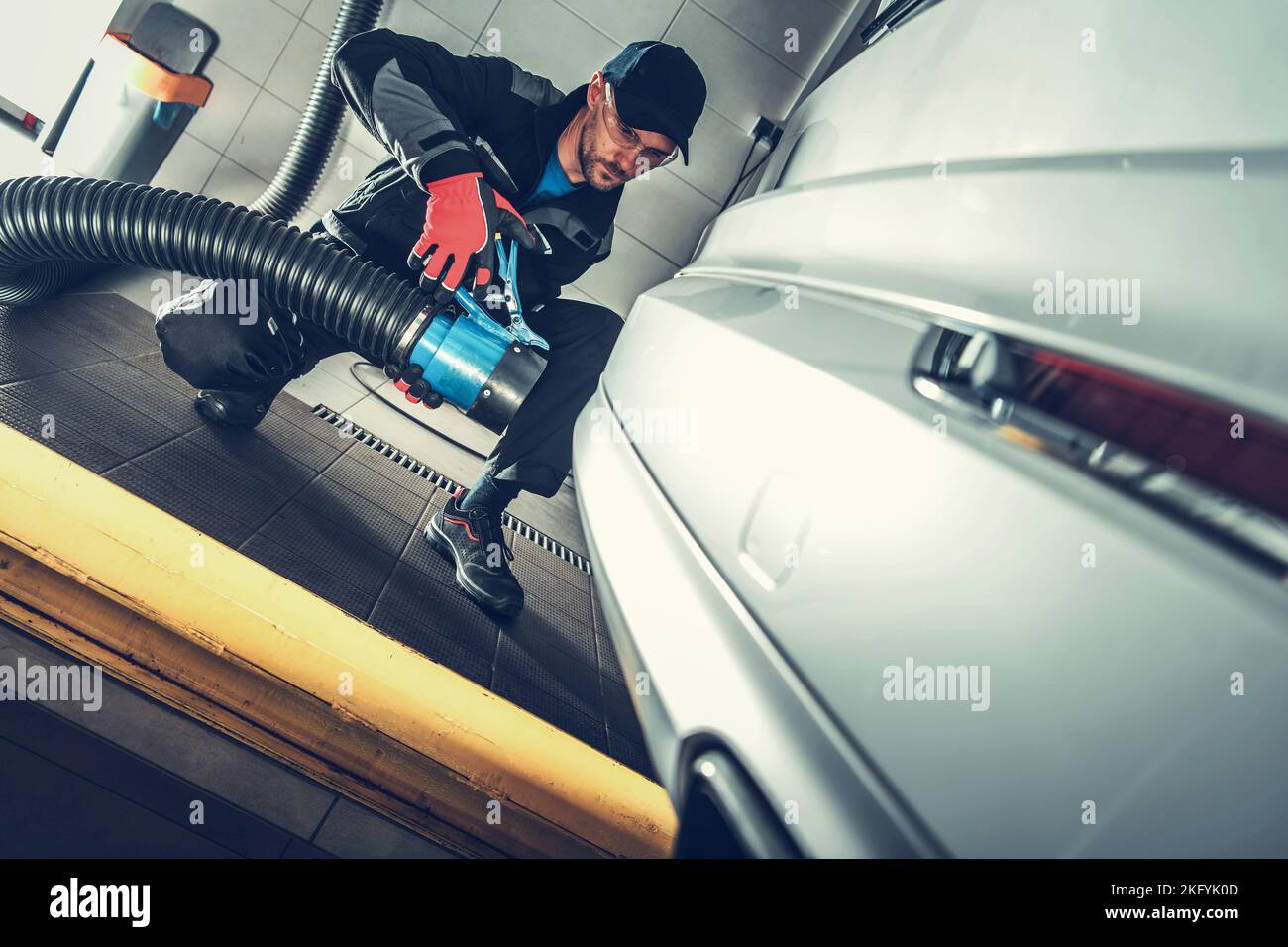 Caucasian Mechanic Performing Diesel Pollution Test During Motor