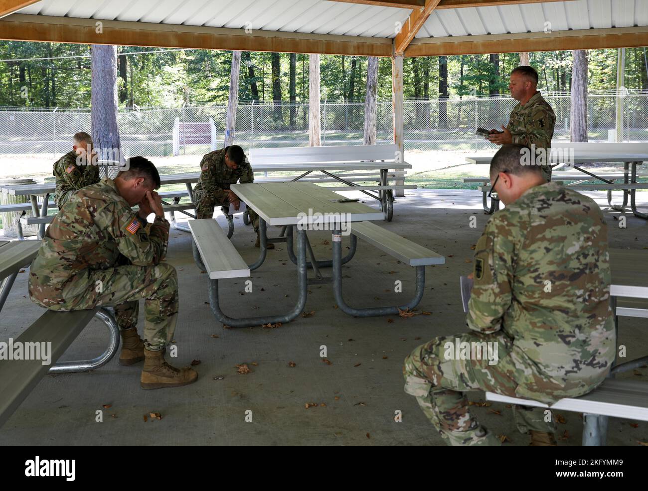 412th TEC Soldiers bow their heads in unified prayer during religious