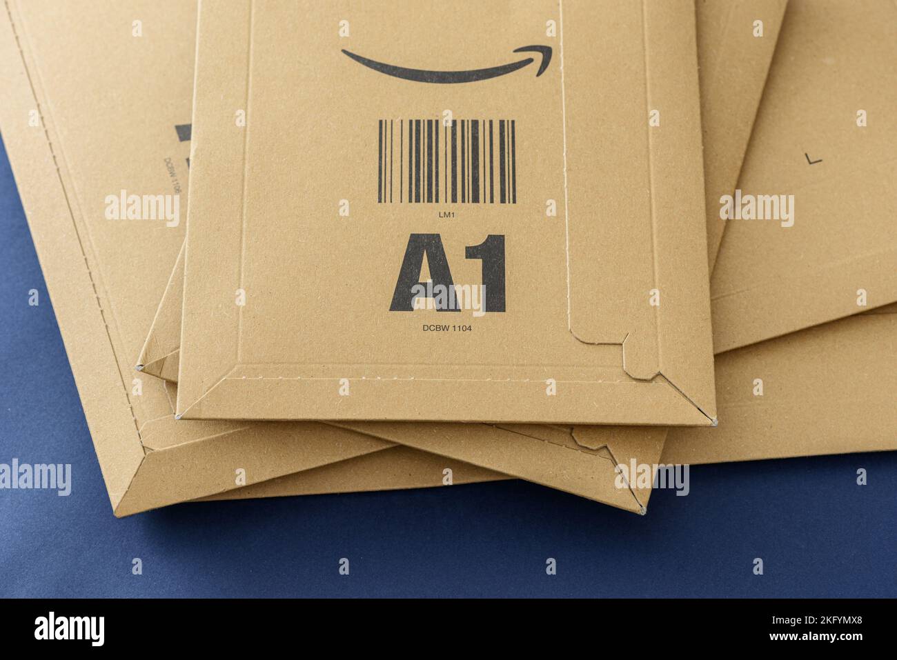 ISTANBUL, TURKEY - NOVEMBER 20, 2022: Amazon logo with sign arrow smiling printed on delivery envelope brown cardboard. Stock Photo