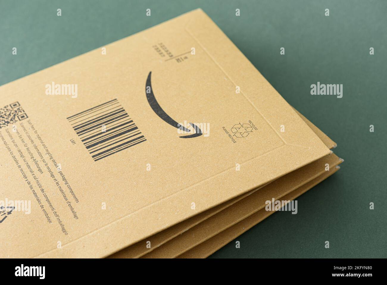 ISTANBUL, TURKEY - NOVEMBER 20, 2022: Amazon logo with sign arrow smiling printed on delivery envelope brown cardboard. Stock Photo