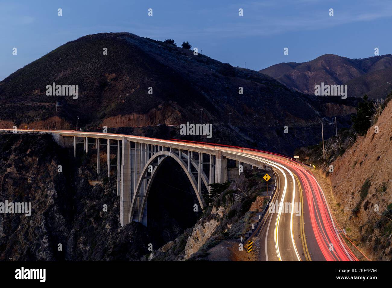 Car light trails illuminating Bixby Creek Bridge. Big Sur, California, USA. Stock Photo
