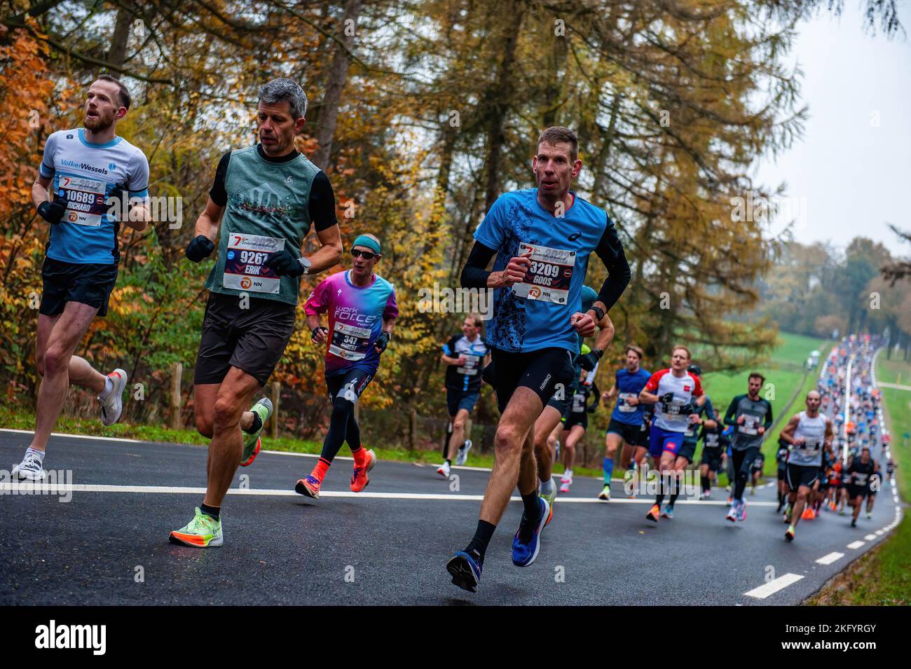 Some runners are seen tired while running the seven hills. About 17,500 participants ran the 'NN Zevenheuvelenloop' which has attracted thousands of runners from The Netherlands and abroad to Nijmegen for years. The course is considered one of the most beautiful in the country. In the men's race, Ugandan athlete Rogers Kibet won with a time of 42.08 minutes, and in the women's race, Kenyan athlete Beatrice Chepkoech won with a time of 47.18 minutes. They ran across the very well-known seven hills, located in Berg en Dal before arriving in Nijmegen. The meaning of Zevenheuvelenloop in English w Stock Photo