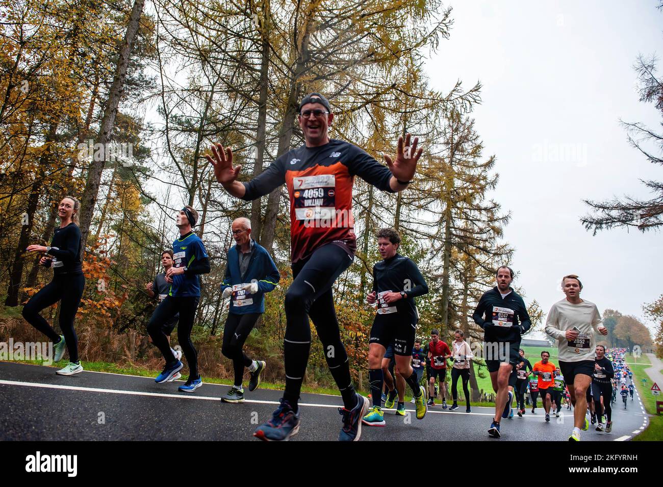 A runner is seen cheering to the camera. About 17,500 participants ran