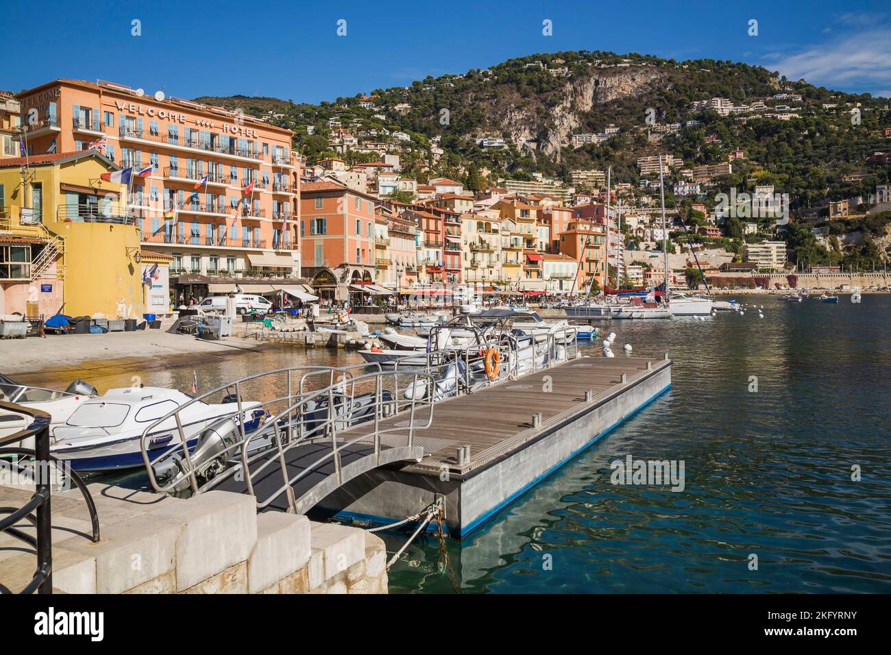 Colourful hotel and apartment building facades and harbour with moored pleasure boats and sailboats, Villefranche-sur-Mer, Provence, France Stock Photo