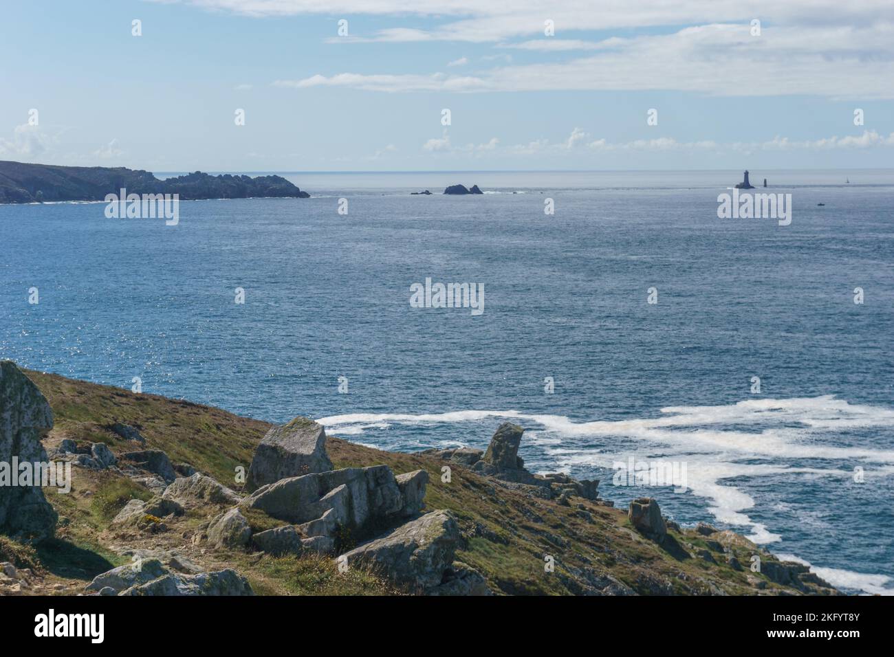 Seascape with path at the coast and view to Pointe du Raz and Vieille lighthouse, Plogoff, Finistere, Brittany, France Stock Photo