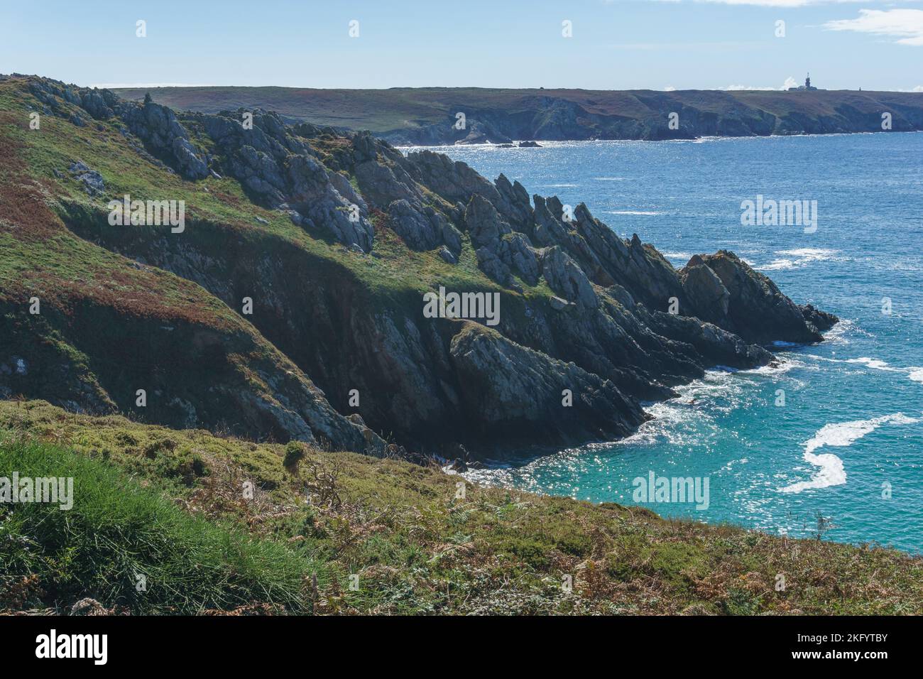 Pointe du Raz as seen from the Pointe du Van along the coastline on a sunny day, Plogoff, Brittany, France Stock Photo