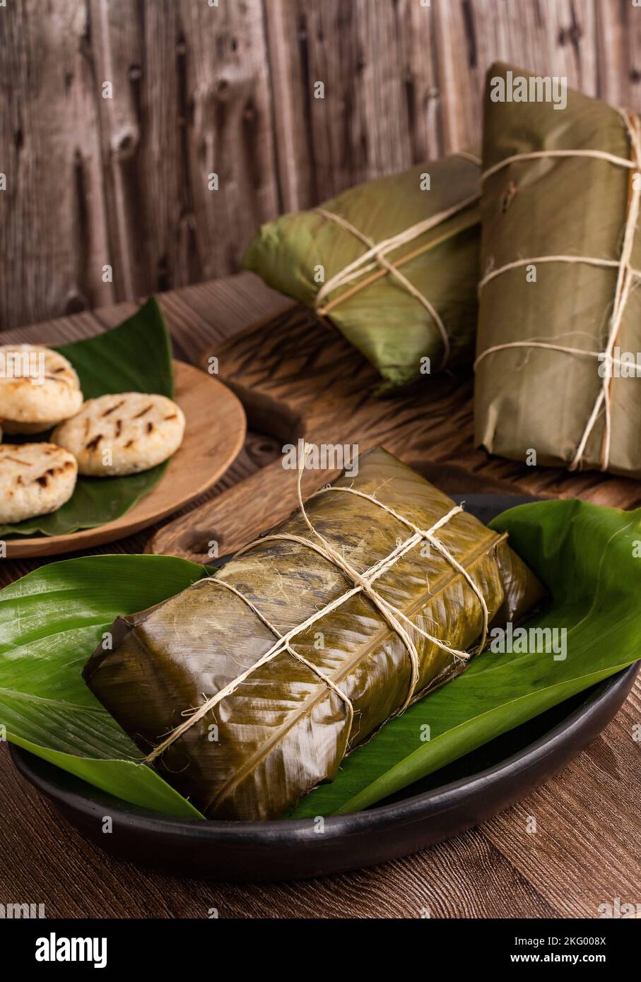 Traditional colombian tamales Wrapped in green banana leaves Stock