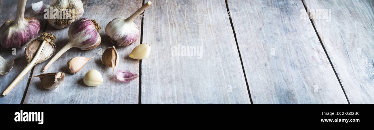 Garlic bulbs and cloves on wooden table, food background, copy space ...