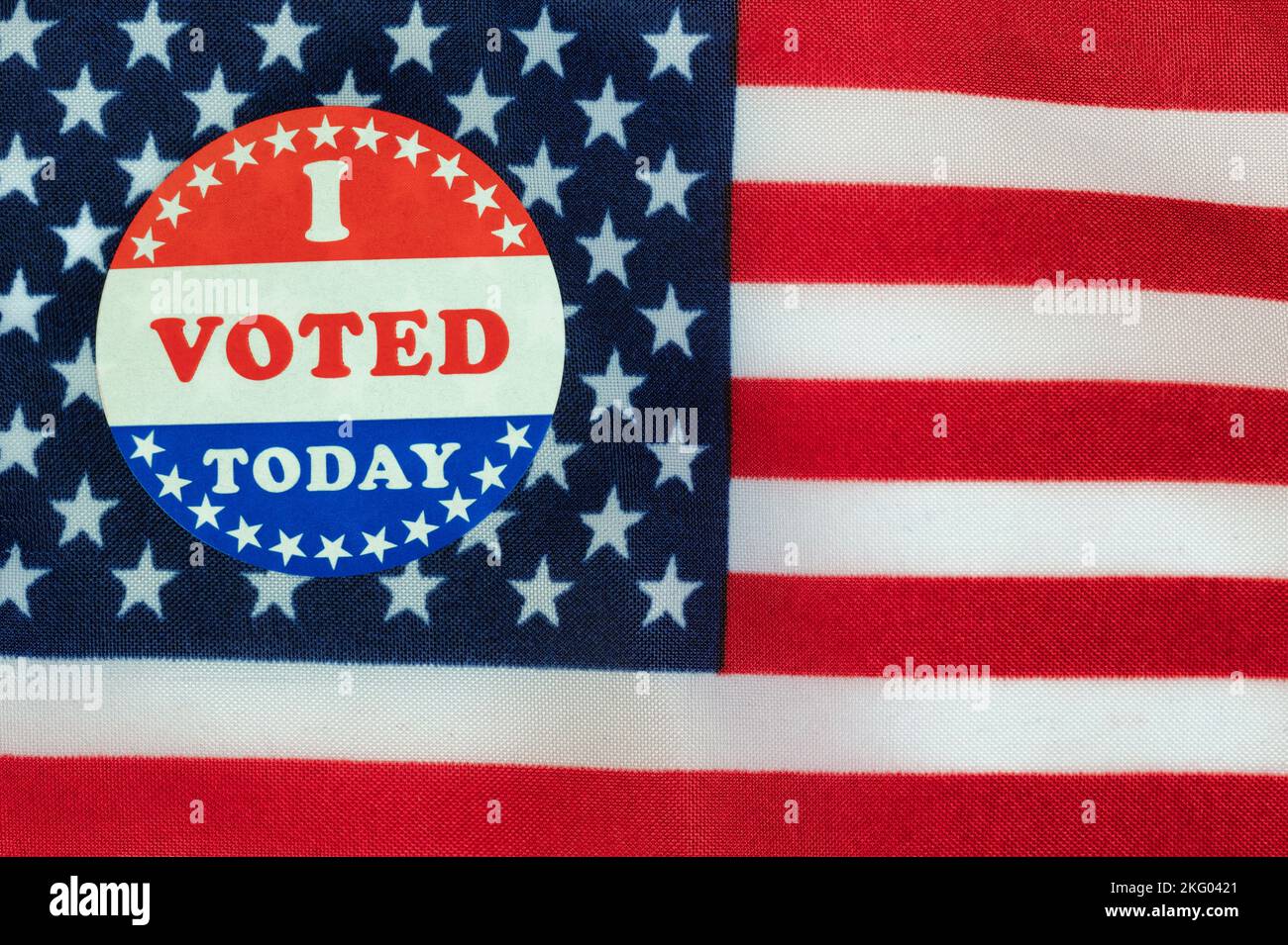 Vote sticker on United States flag background for American election campaign concept Stock Photo