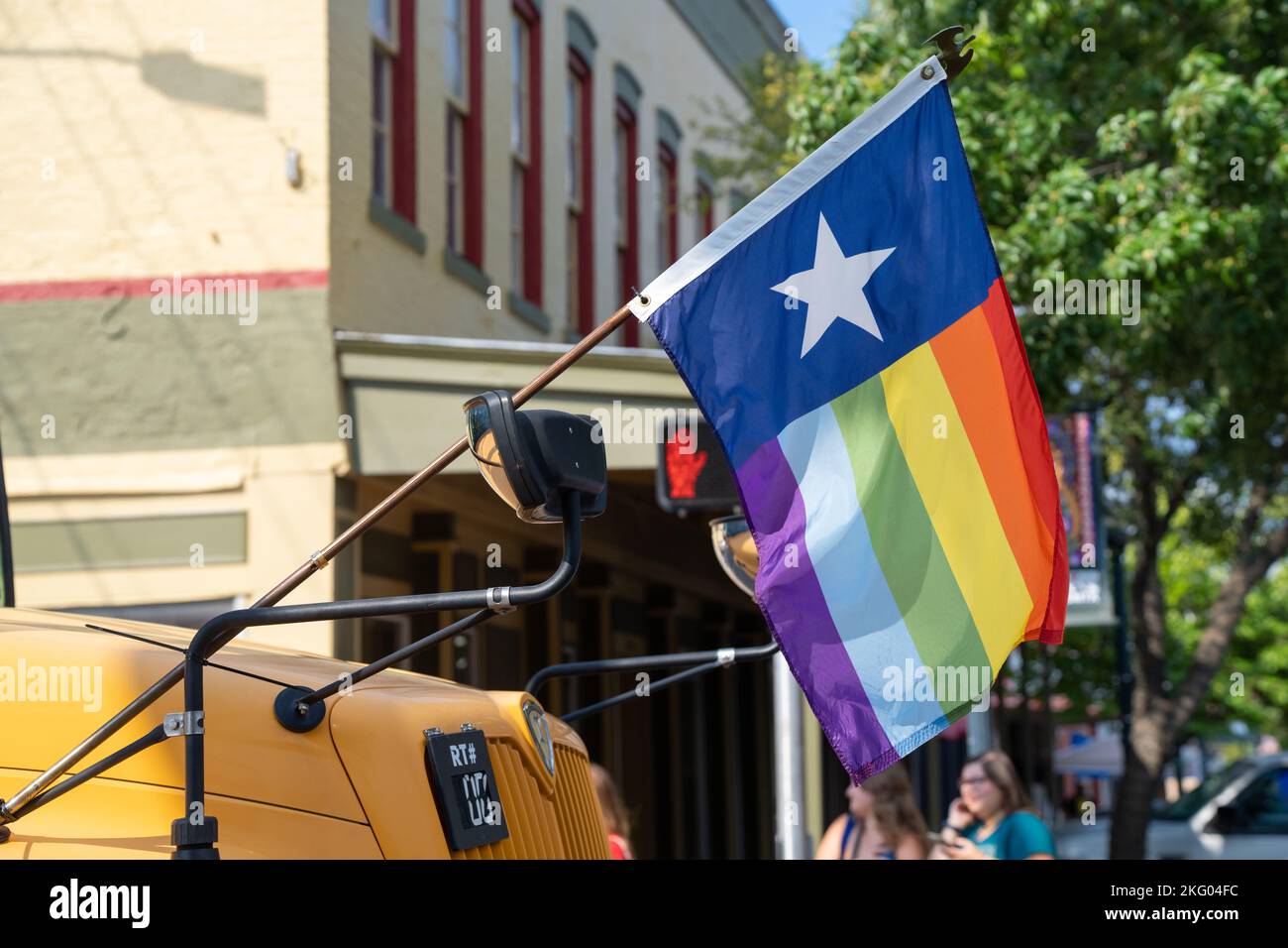 A Texas pride flag is displayed on the front of a school bus during the San Marcos Pride anti-bully parade. Stock Photo