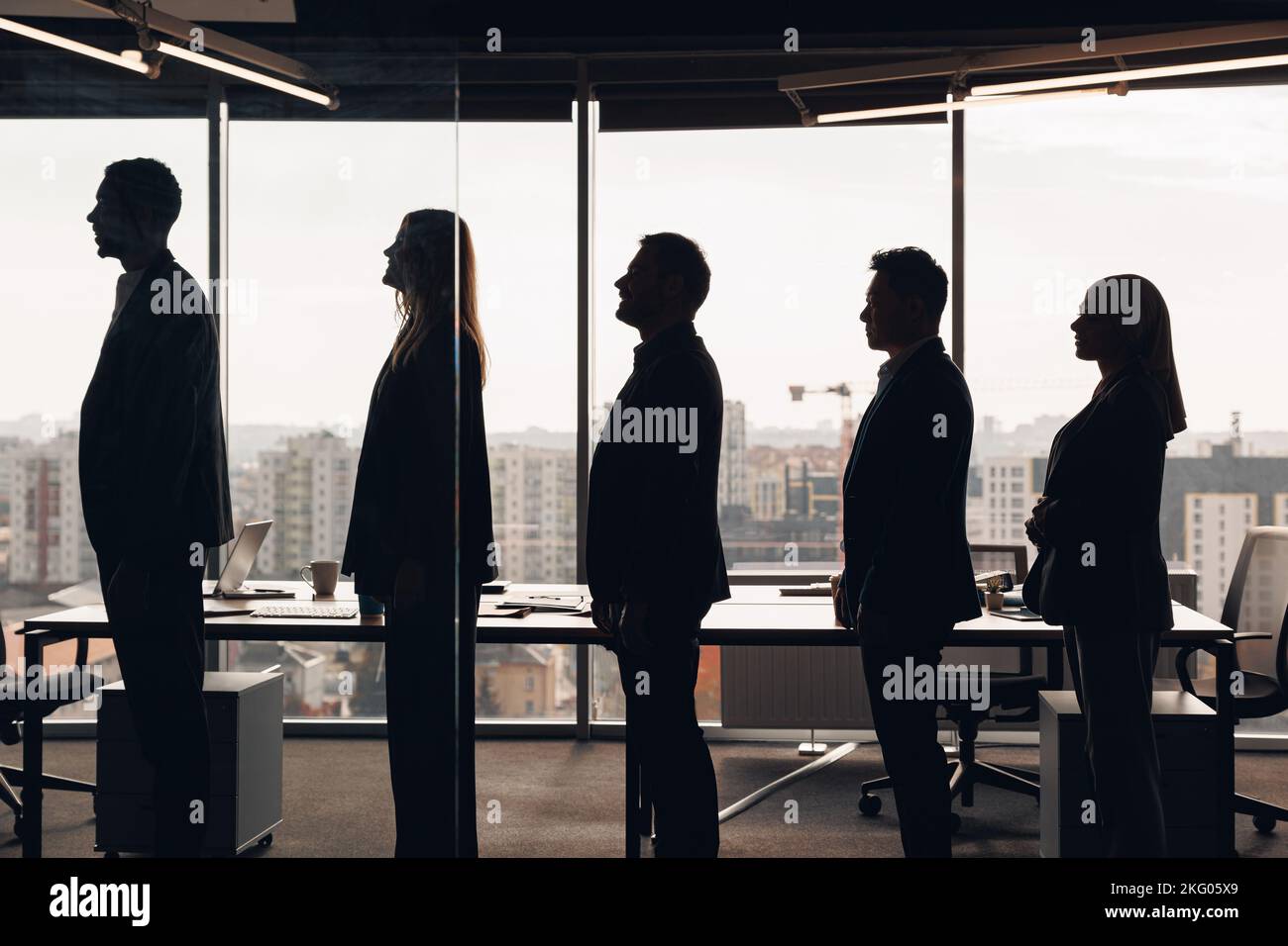 Silhouette photo of a group of businessmen standing side by side in ...