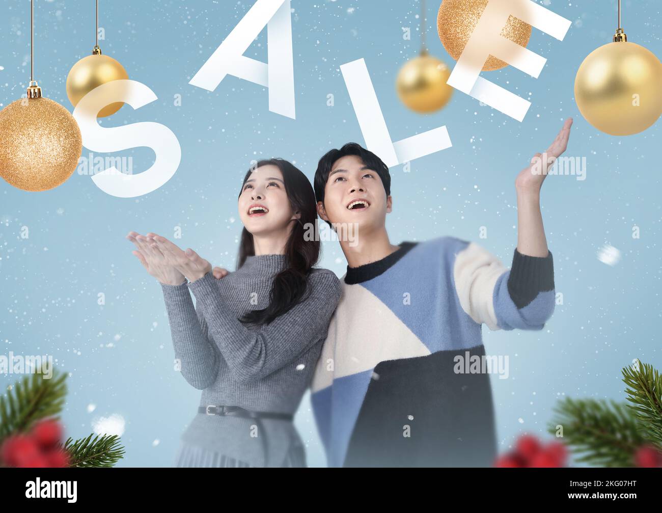 winter shopping sale event poster falling snow and Asian Korean couple Stock Photo